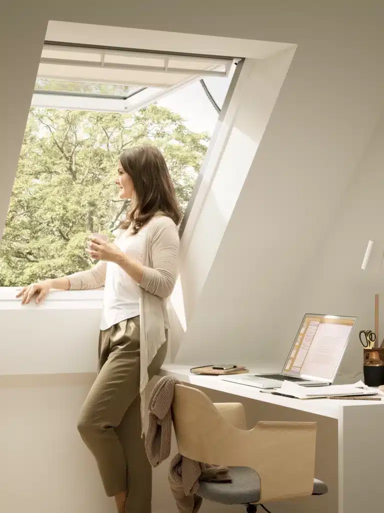 Fenêtre de toit ouverte dans un espace de travail sous combles — VELUX